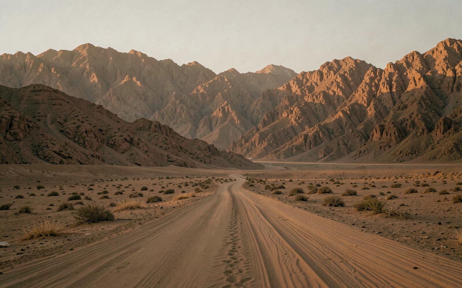 Desert mountains and an empty track near Dahab at golden hour